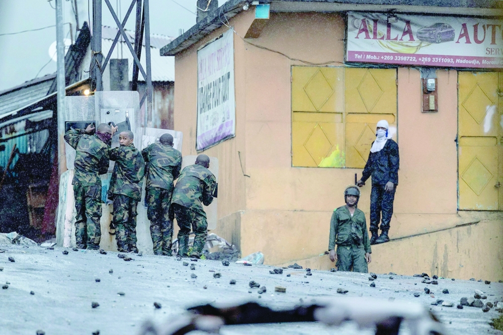 Security forces face opposition demonstrators throwing stones at them in Moroni, following the announcement of the presidential election results. — AFP file photo 