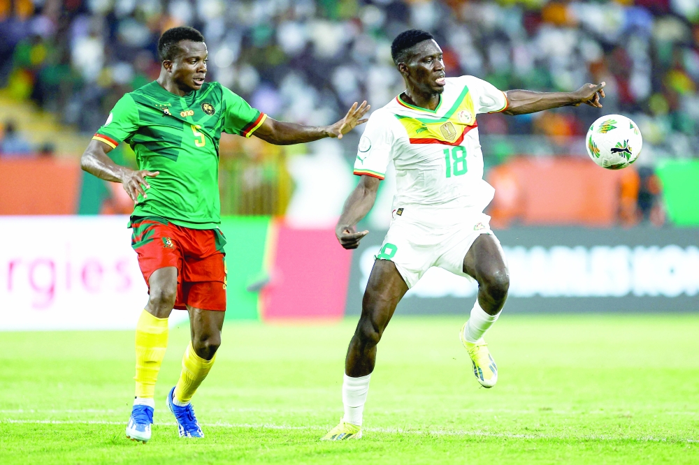 Senegal's forward #18 Ismaila Sarr fights for the ball with Cameroon's defender #5 Nouhou Tolo during the Africa Cup of Nations (CAN) 2024 group C football match between Senegal and Cameroon at the Stade Charles Konan Banny in Yamoussoukro on January 19, 2024.