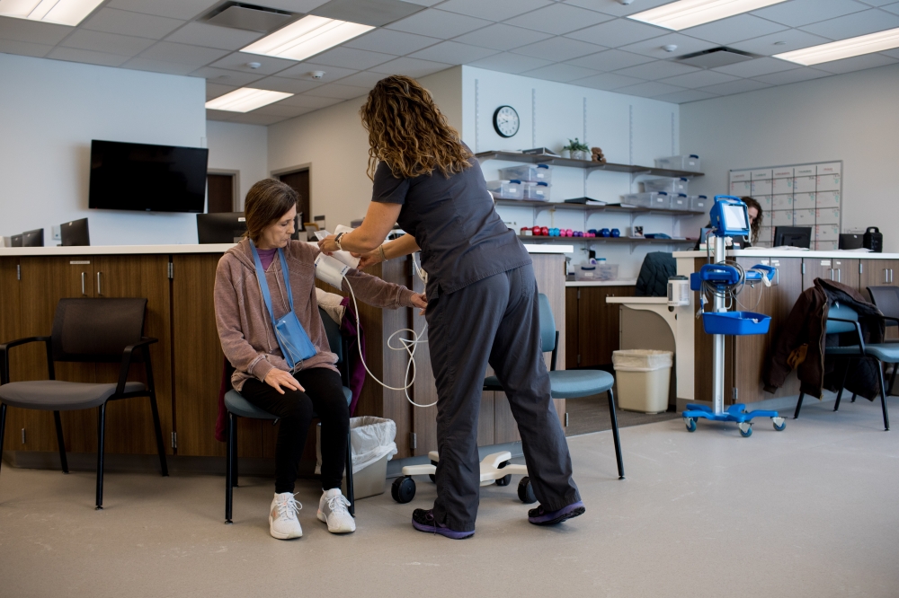 Cynthia Mosson, 61 and recovering from emergency open-heart surgery last year, has her blood pressure taken during a therapy appointment in Frankfort, Ind., Jan. 19, 2024. (Kaiti Sullivan/The New York Times)