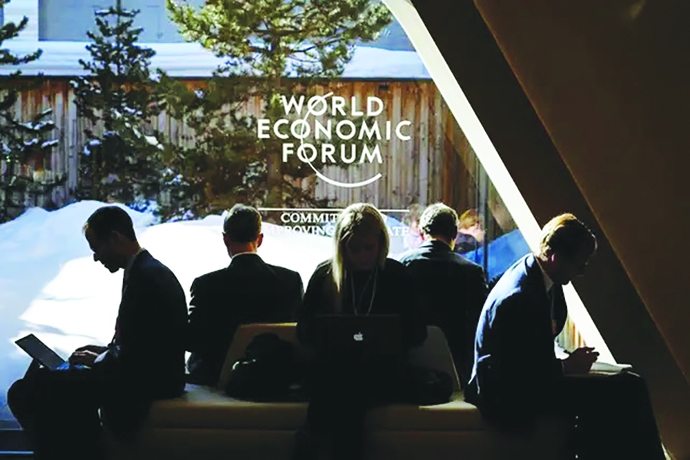 Participants check messages on electronic devices at the World Economic Forum (WEF) in Davos. 