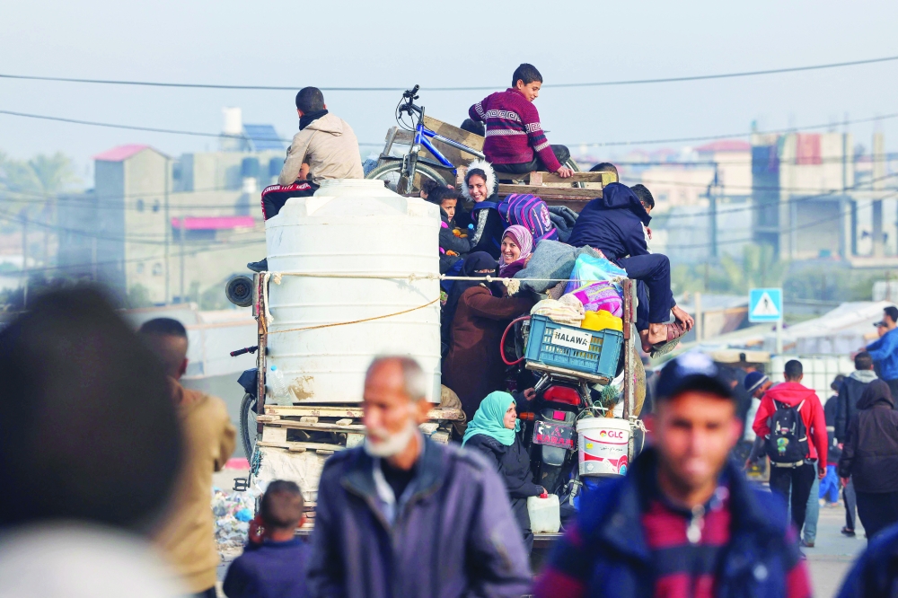 Displaced Palestinians leave a makeshift tent camp in Rafah in a truck loaded with their belongings heading to central areas of Gaza. — AFP 