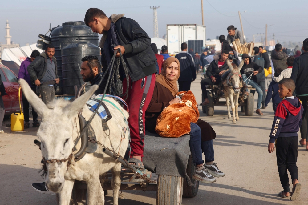 Displaced Palestinians at a makeshift tent camp in Rafah near the border with Egypt in the southern Gaza Strip 