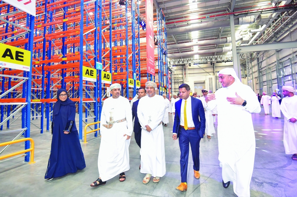 Eng Khamis bin Mohammed al Shamakhi tours the facilities of FLAG Logistics, along with other dignitaries, on Sunday.