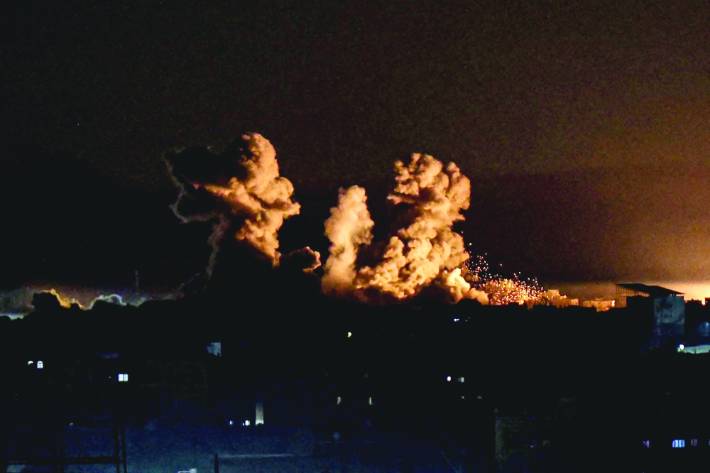 This photograph shows smoke billowing during Israeli bombardment over Khan Yunis in the southern Gaza Strip. — AFP 