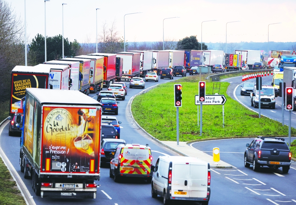 Trucks queue on the road leading to the Waterbrook Inland Border Facility, a temporary customs clearance centre set up in a truck stop in Ashford.