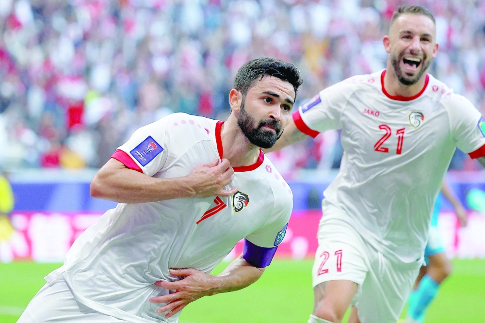 Syria's forward #07 Omar Khribin celebrates after scoring his team's first goal during the Qatar 2023 AFC Asian Cup Group B football match between Syria and India at Al-Bayt Stadium in al-Khor, north of Doha, on January 23, 2024.