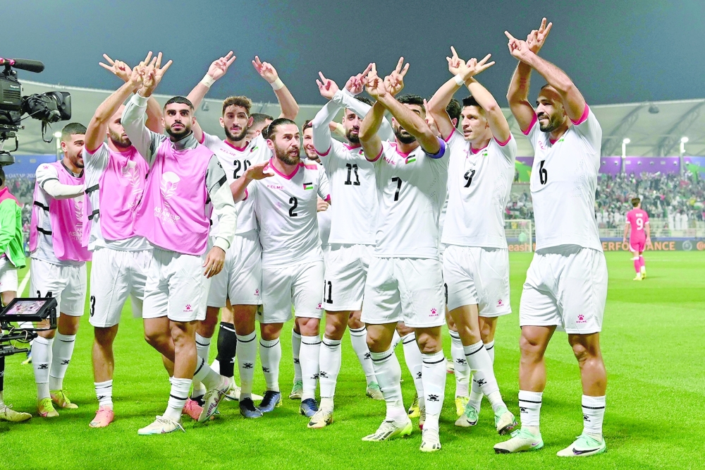 Palestine's forward #11 Oday Dabbagh celebrates with team-mates after scoring the first goal during the Qatar 2023 AFC Asian Cup Group C football match between Hong Kong and Palestine at the Abdullah bin Khalifa Stadium in Doha on January 23, 2024.