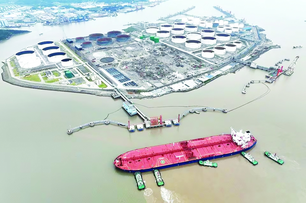 Tugboats guide a crude oil tanker at a Zhoushan oil terminal. (Credit: Reuters)