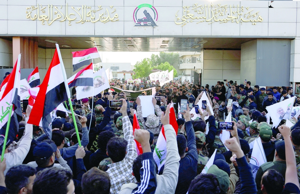 Mourners carry the coffins of fighters who were killed by US airstrike in Jurf al-Sakhar, during a funeral in south Baghdad, Iraq. — Reuters 