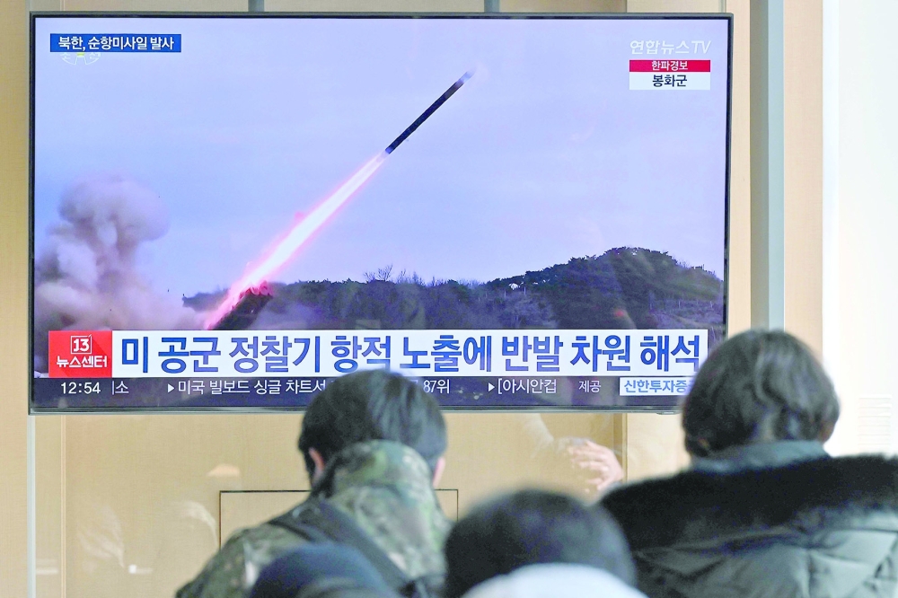People watch a television screen showing a news broadcast with file footage of a North Korean missile test, at a railway station in Seoul. — AFP 