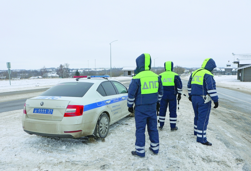 Traffic police officers block off a road near the crash site of the Russian Ilyushin Il-76 military transport plane outside the village of Yablonovo in the Belgorod Region, Russia. — Reuters 