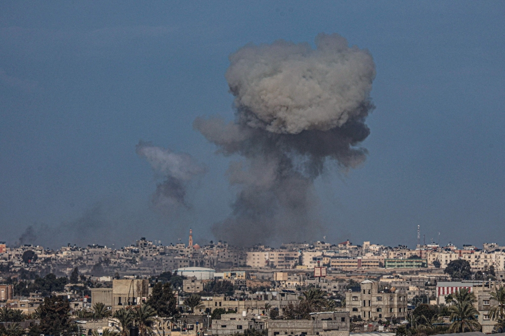 Smoke billows over buildings is Rafah in the southern Gaza Strip during Israeli bombardment on January 25