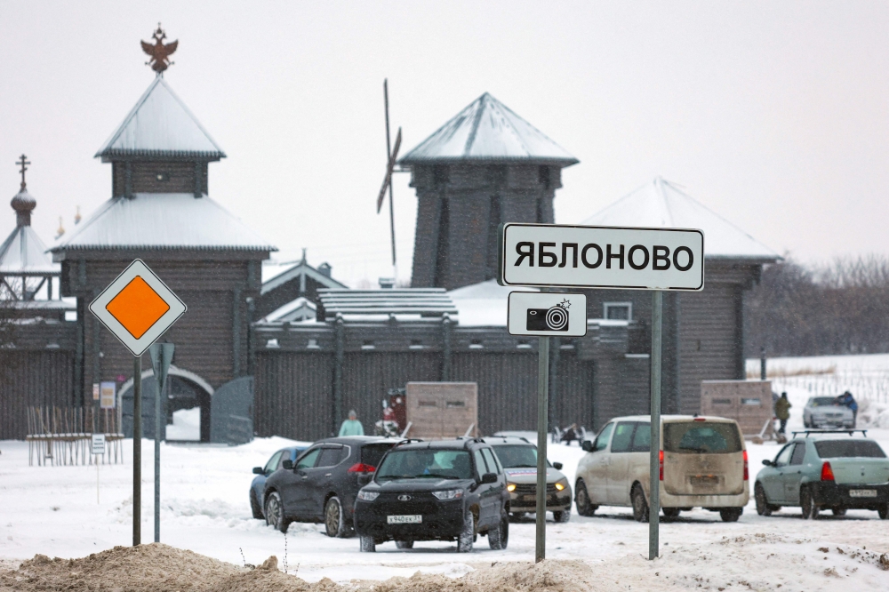 A road sign sits in the village of Yablonovo near the Russian IL-76 military transport plane crash site in the Belgorod region. - AFP