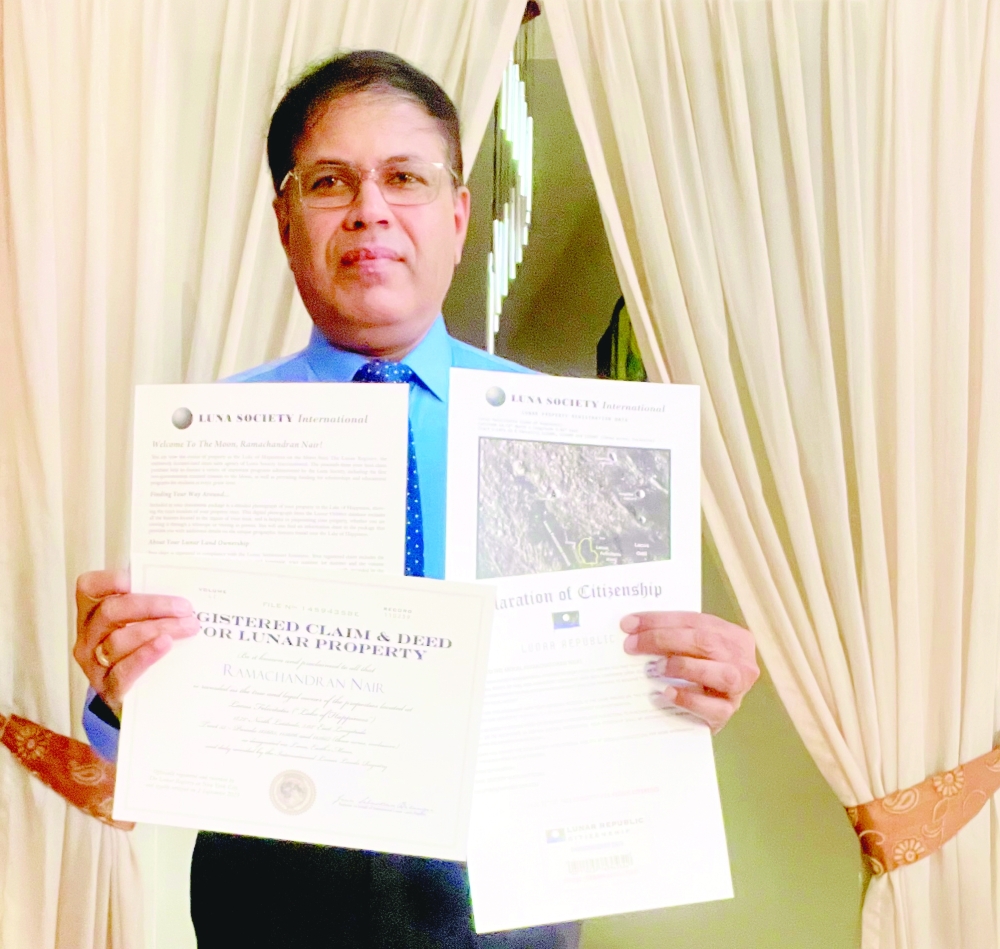 Ramachandran Nair holds the lunar legacy from The Lunar Registry, with ‘Lake of Happiness’ claim