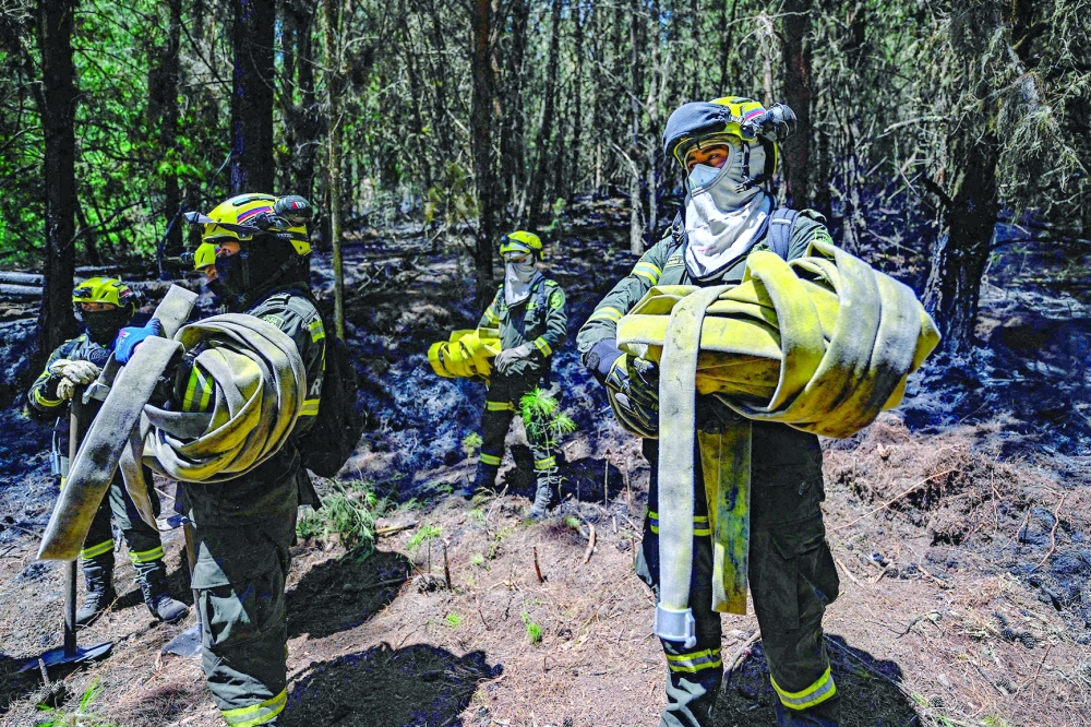 Firefighters work at the site of a forest fire in Nemocon, Colombia. — AFP