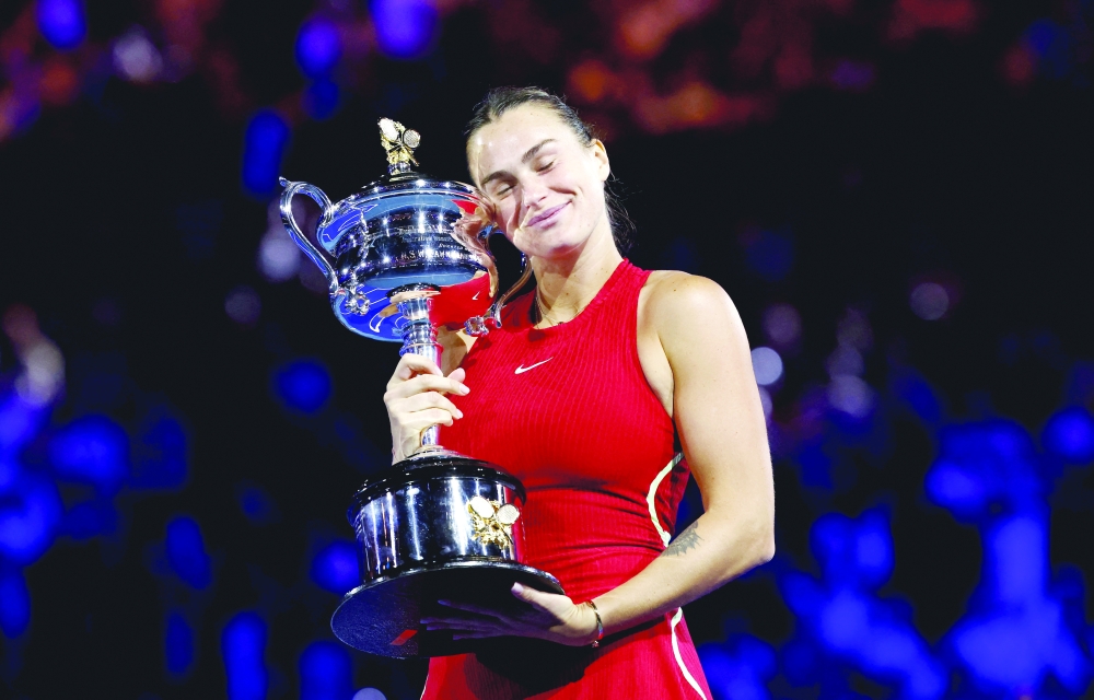 Tennis - Australian Open - Melbourne Park, Melbourne, Australia - January 27, 2024 Belarus' Aryna Sabalenka celebrates with the trophy after winning the final against China's Qinwen Zheng.
