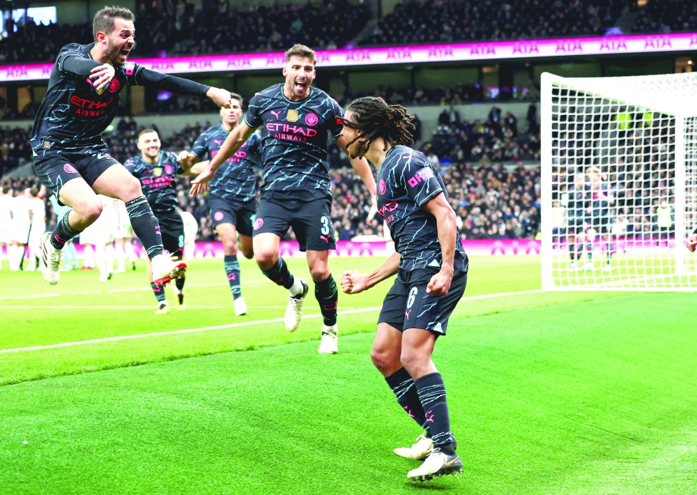Soccer Football -  FA Cup - Fourth Round - Tottenham Hotspur v Manchester City - Tottenham Hotspur Stadium, London, Britain - January 26, 2024  Manchester City's Nathan Ake celebrates scoring their first goal with Bernardo Silva and Ruben Dias REUTERS/David Klein