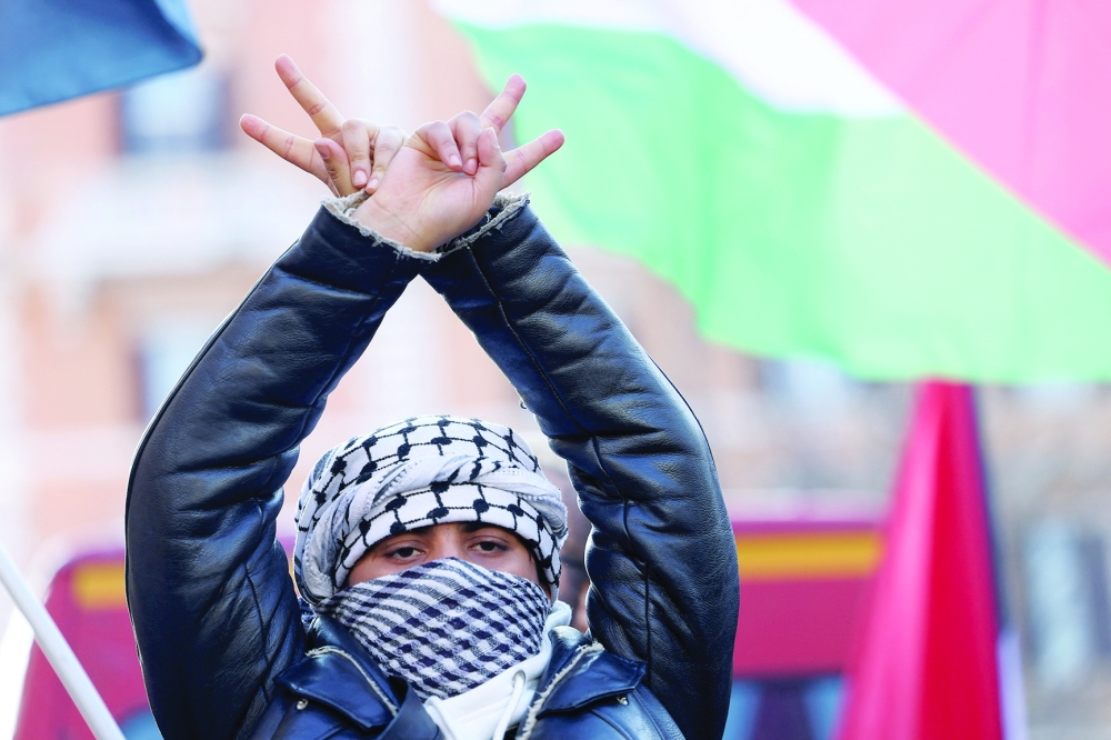 A pro-Palestinian protester gestures in Rome, Italy, during a demonstration on Saturday demanding an immediate ceasefire in Gaza. - Reuters