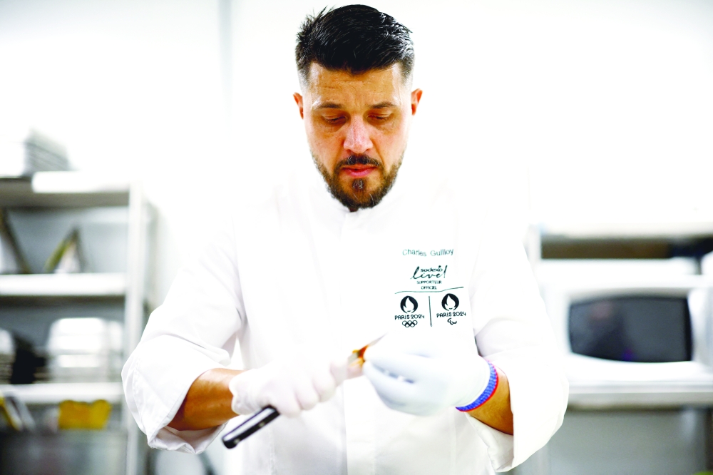 The executive chef for the Paris 2024 Olympic Games, Charles Guilloy, prepares a dish that will be served to athletes competing in the Paris Olympics and Paralympics 2024, in Rungis, near Paris, France January 26, 2024. REUTERS/Sarah Meyssonnier