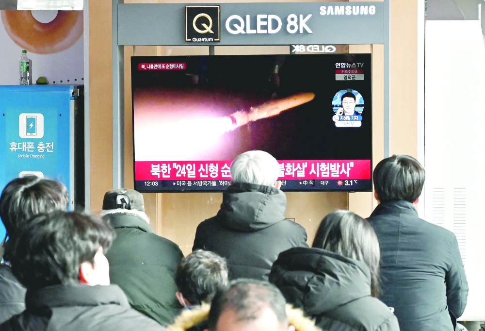 People watch a television screen showing a news broadcast with file footage of a North Korean missile test, at a railway station in Seoul. — AFP 