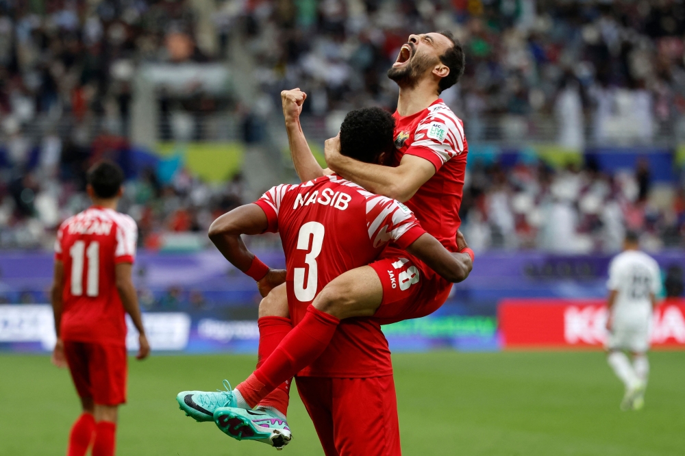 Jordan's players celebrate their team's second goal during the Qatar 2023 AFC Asian Cup football match against Iraq 
