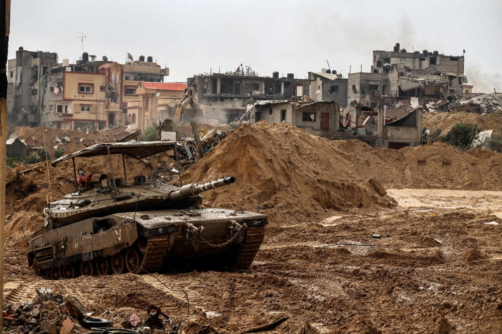 This picture shows an Israeli army tank rolling in Gaza's main southern city of Khan Yunis. — AFP