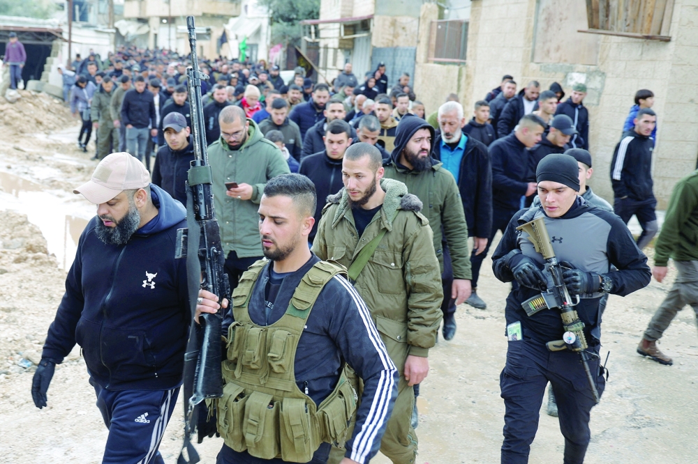 Gunmen attend the funeral of three Palestinians that were killed during an Israeli raid in a hospital, in Jenin, in the Israeli-occupied West Bank. — Reuters