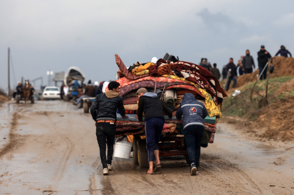 Palestinians transport some of their belongings as the flee Khan Yunis in the southern Gaza Strip further south. -