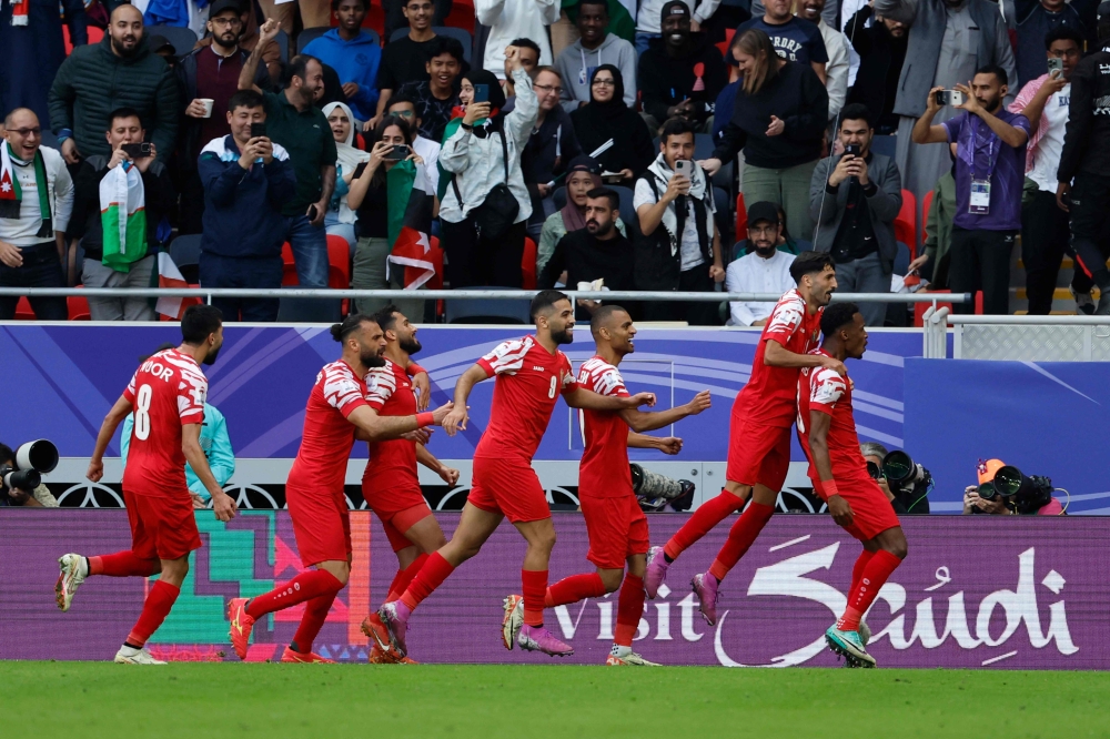 Jordan's defender #03 Abdallah Nasib celebrates scoring his team's first goal during the Qatar 2023 AFC Asian Cup quarter-final football match between Tajikistan and Jordan at the Ahmad Bin Ali Stadium in Al-Rayyan, west of Doha on February 2, 2024.  (Photo by KARIM JAAFAR / AFP)

