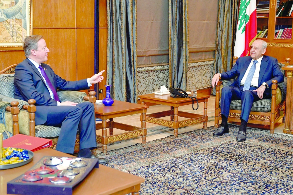 Lebanese Parliament Speaker Nabih Berri (R) talks with British Foreign Secretary David Cameron during their meeting in Beirut. — AFP file photo 