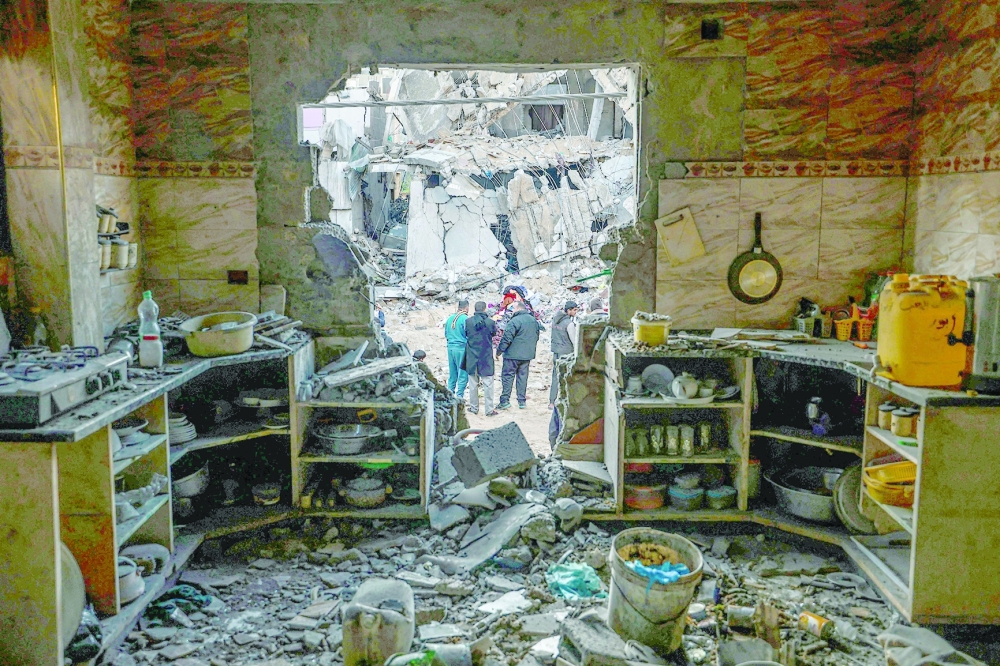 People check the damage following Israeli bombardment in Rafah in the southern Gaza Strip. — AFP 