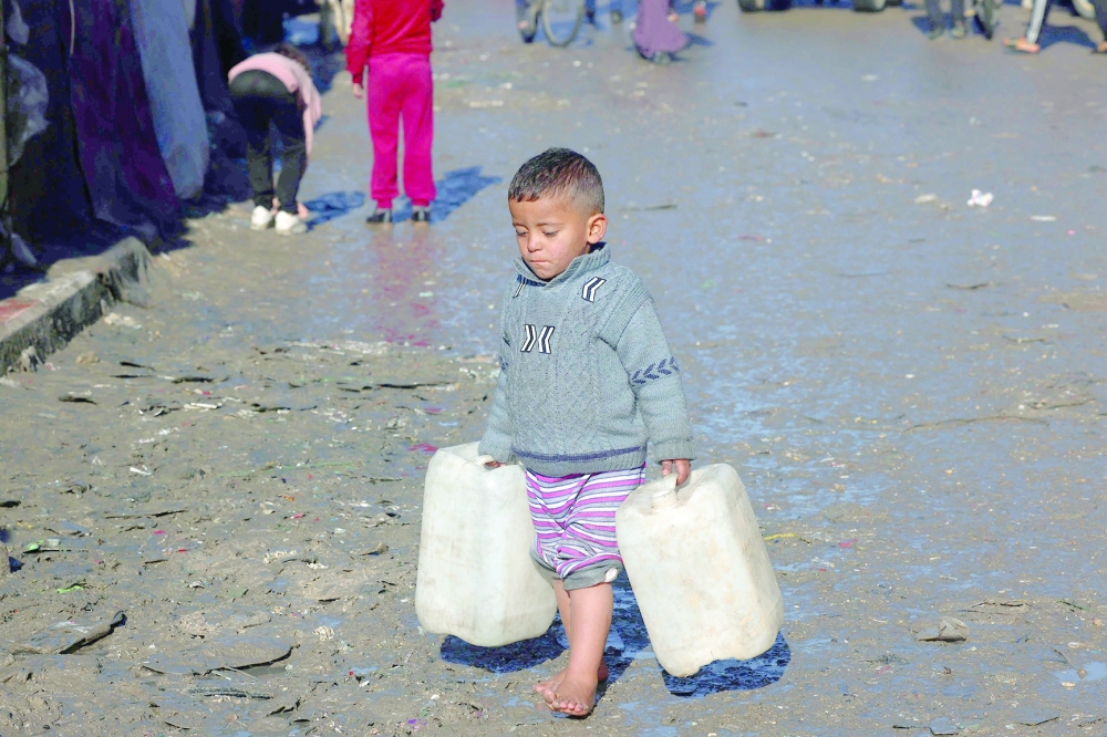 A young boy carries empty jerricans in Rafah in the southern Gaza Strip. — AFP 