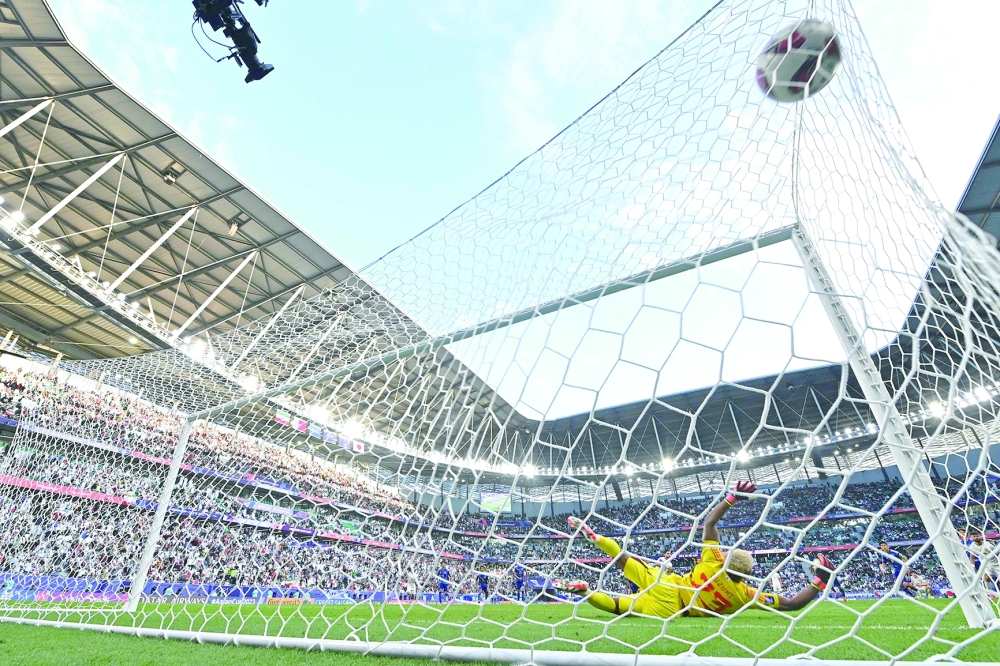 Zion Suzuki concedes a penalty goal by Iran's Alireza Jahanbakhsh. — AFP