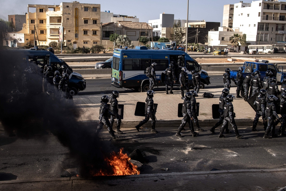 Senegalese gendarmes patrol a road during demonstrations called by the opposition parties in Dakar. — AFP 