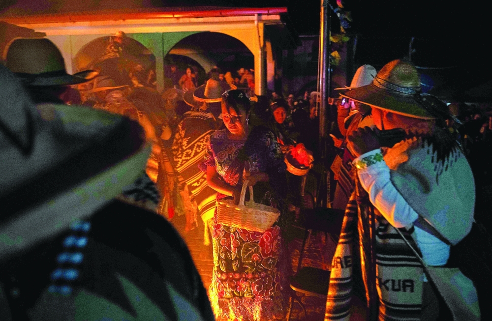 Purepecha痴 Indigenous community members light wooden sticks during a ceremony in Ocumicho indigenous village, Michoacan State, Mexico, on February 1, 2024. Every year, Purepecha痴 Indigenous people from different regions of Michoacan State celebrate the Fuego Nuevo Purepecha (Purepecha痴 New Fire), a fire lighting ceremony to mark the start of the new year.