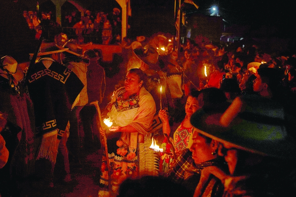 Purepecha痴 Indigenous community members light wooden sticks during a ceremony in Ocumicho indigenous village, Michoacan State, Mexico, on February 1, 2024. Every year, Purepecha痴 Indigenous people from different regions of Michoacan State celebrate the Fuego Nuevo Purepecha (Purepecha痴 New Fire), a fire lighting ceremony to mark the start of the new year.