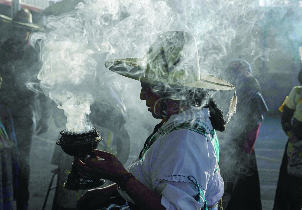 A Purepecha Indigenous woman holds incense during a 3-day ceremonial procession from Cocucho to Ocumicho indigenous villages in Michoacan State, Mexico, on January 31, 2024. Every year, Purepecha痴 Indigenous people from different regions of Michoacan State celebrate the Fuego Nuevo Purepecha (Purepecha痴 New Fire), a fire lighting ceremony to mark the start of the new year.