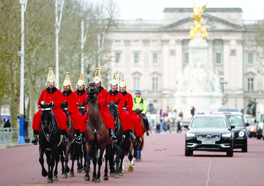 Life Guards, a unit of the Household Cavalry, ride their horses past Buckingham Palace in London. — AFP