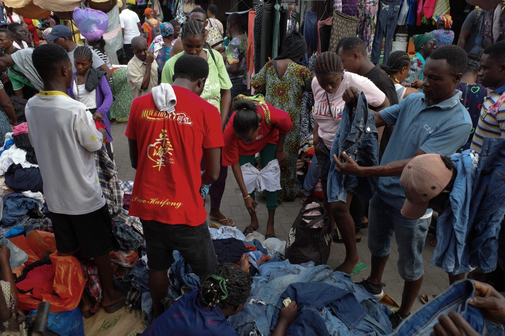 Buyers search for secondhand clothes at the Kantamanto market in Accra,