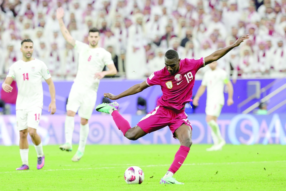 Qatar's forward #19 Almoez Ali scores his team's third goal during the Qatar 2023 AFC Asian Cup semifinal football match between Iran and Qatar at Al Thumama Stadium in Doha on February 7, 2024.