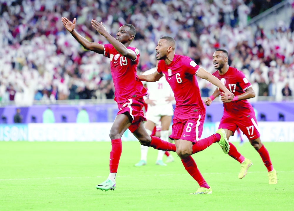 AFC Asian Cup - Semi Final - Iran v Qatar - Al Thumama Stadium, Doha, Qatar - February 7, 2024 Qatar's Almoez Ali celebrates scoring their third goal with Abdulaziz Hatem.