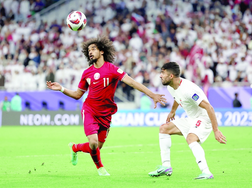 AFC Asian Cup - Semi Final - Iran v Qatar - Al Thumama Stadium, Doha, Qatar - February 7, 2024 Qatar's Akram Afif in action with Iran's Milad Mohammadi.
