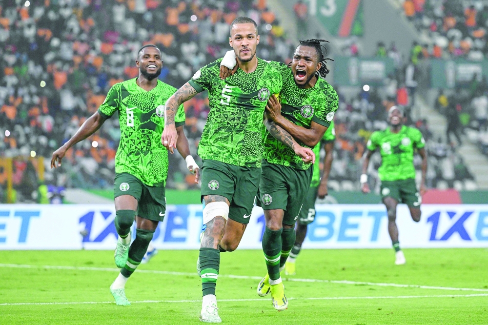 Nigeria's defender #5 William Troost-Ekong (C) celebrates with team-mates after scoring his team's first goal from the penalty spot during the Africa Cup of Nations (CAN) 2024 semifinal football match between Nigeria and South Africa at the Stade de la Paix in Bouake on February 7, 2024.
