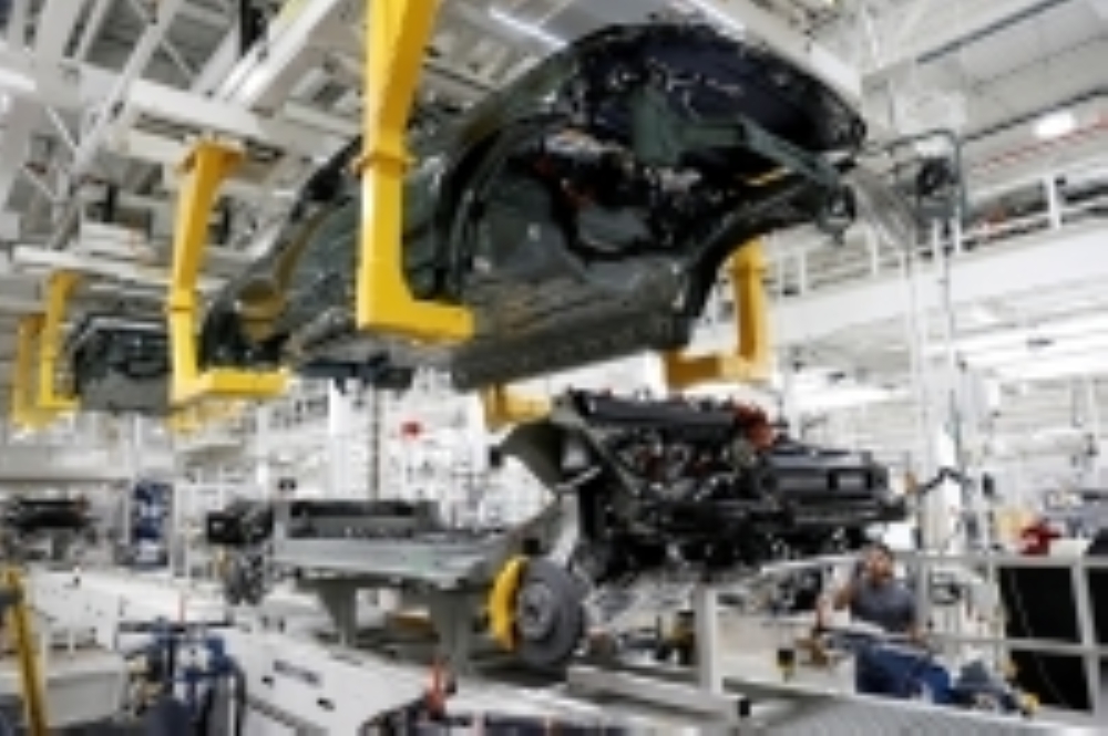 An employee works on an assembly line at a startup electric vehicle factory 