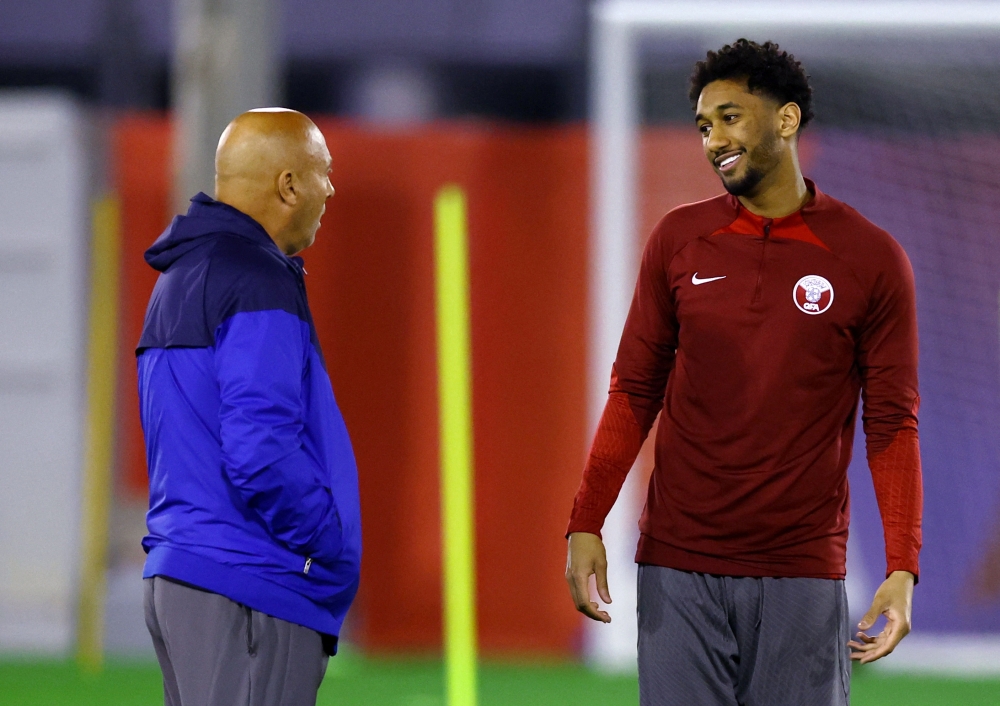 Qatar coach Tintin Marquez and Homam Ahmed during training 