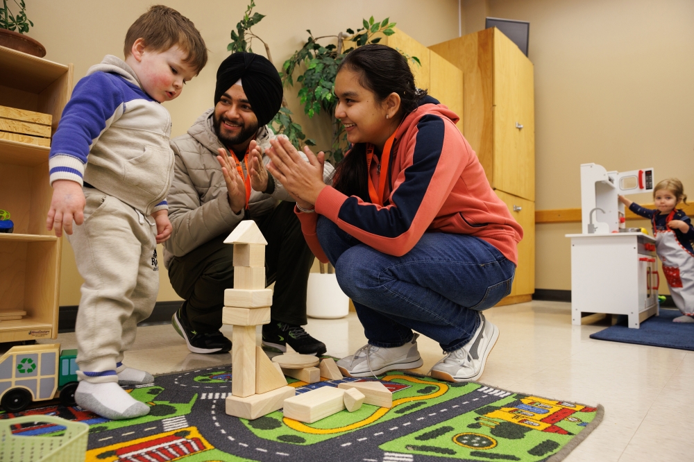 Harinder Singh and Menakpreet Kaur, both early childhood education students at Northern College, during an in-class exercise with local children, in Timmins, Ontario. - TNYT
