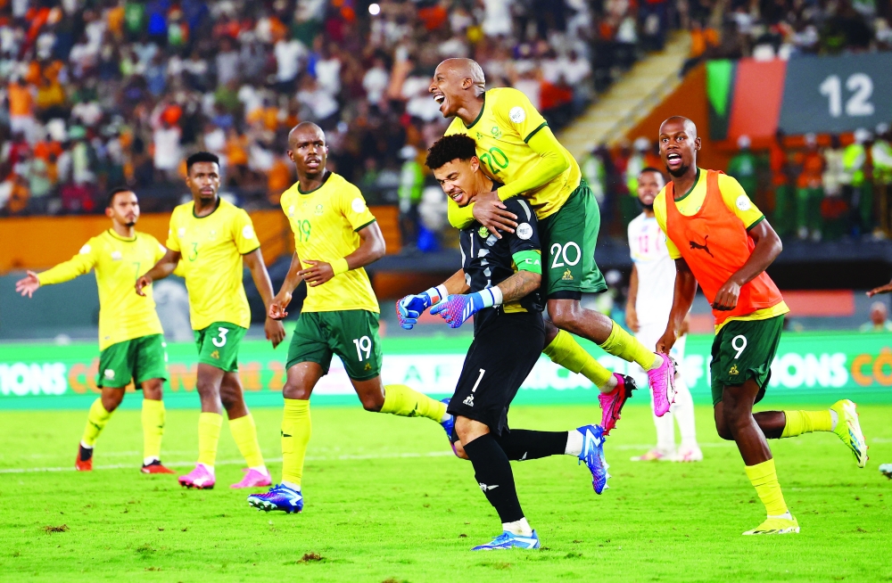 South Africa's Ronwen Williams and Khuliso Mudau celebrate after winning the penalty shootout.— REUTERS
