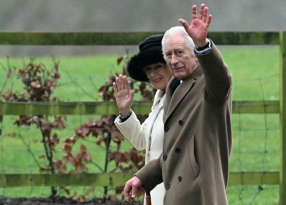 Britain's King Charles III and Britain's Queen Camilla leave after attending a service at St Mary Magdalene Church on the Sandringham Estate in eastern England. - AFP