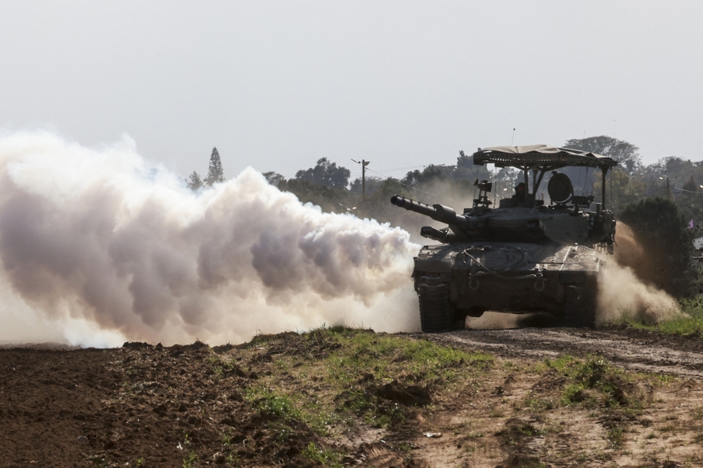 Israeli tanks roll near the border with the Gaza Strip on February 14, 2024, amid ongoing fighting between Israel and the Palestinian Hamas militant group.