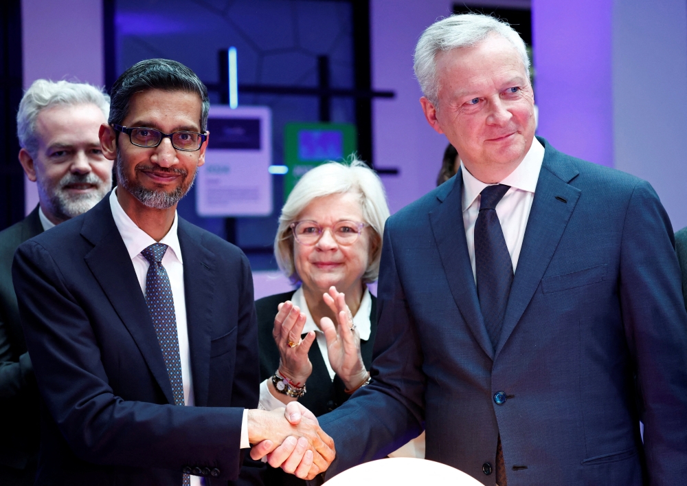Sundar Pichai, CEO of Google and Alphabet, shakes hands with French Minister for Economy, Finance, Industry and Digital Security Bruno Le Maire during the inauguration of a new AI hub at the Google France headquarters in Paris on Thursday. — AFP 